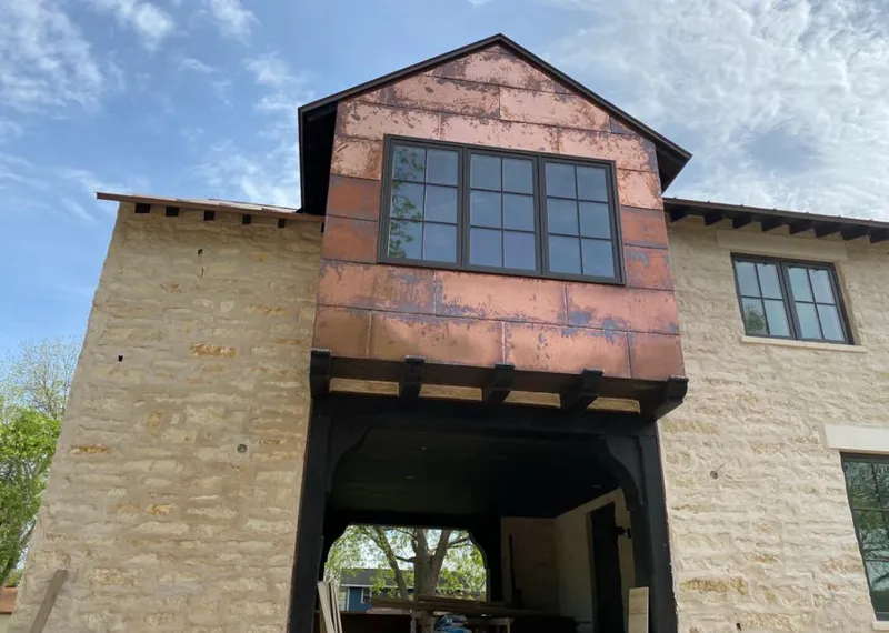 Copper metal panel facade on a stone building for Skylight Installation in Beachwood